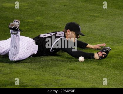 Colorado Rockies center fielder Cory Sullivan can't come up with a ball hit by Boston Red Sox's Jacoby Ellsbury during the third inning in Game 3 of the baseball World Series Saturday, Oct. 27, 2007, at Coors Field in Denver. (AP Photo/Eric Gay)