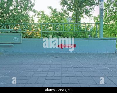 Bomb shelter sign on the building wall. The inscription in Ukrainian SHELTER on the wall. Signpost direction to the bomb shelter in Ukrainian. KYIV, U Stock Photo