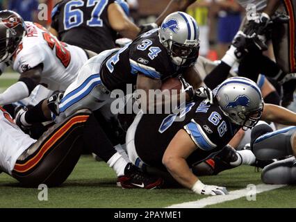 Detroit Lions running back Kevin Jones, (34) breaks away from Buffalo Bills  linebacker Angelo Crowell for a 7-yard touchdown in the first quarter of  their NFL football game in Detroit, Sunday, Oct.