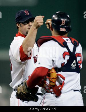 Boston Red Sox pitcher Eric Gagne (L) takes the ball from catcher