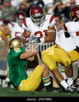 https://l450v.alamy.com/450v/2payrrg/southern-california-running-back-stanley-havili-top-is-tackled-by-notre-dame-safety-tom-zbikowski-lower-left-in-the-first-quarter-of-college-football-action-in-south-bend-ind-saturday-oct-20-2007-ap-photomichael-conroy-2payrrg.jpg