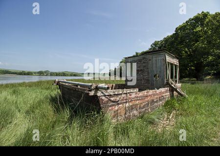 Worn boat beside the River Tiddy at Port Eliot Stock Photo