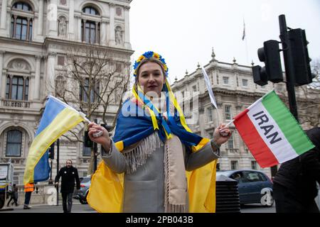 London, UK - March 11, 2023: Ukrainian girl supports Iran's Woman, Life, Freedom movement. Dozens of Ukranian and Brits gathered togehter in a protest asking the UK Government to support Ukranians with more weapons and arms. Credit: Sinai Noor/Alamy Live News Stock Photo