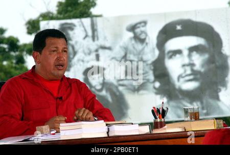 Venezuela's President Hugo Chavez hosts his weekly radio and television  show "Alo, Presidente!" next to an image of Cuba's revolutionary leader  Ernesto 'Che' Guevara, in Santa Clara, Cuba, Sunday, Oct. 14, 2007.