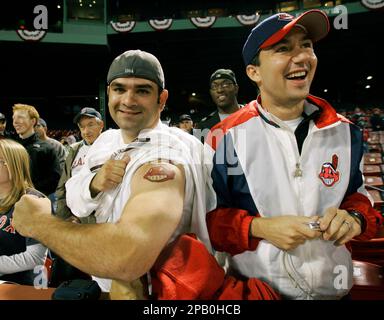 A fan of the Boston Red Sox displays his tattoos before a game