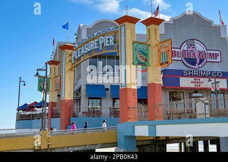 Galveston, Texas, USA - February 2023: People walking up the ramp to the entrance of the historic pier on the seafront of Galveston Stock Photo