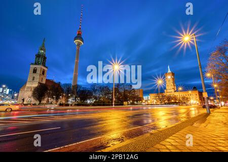 The famous TV Tower, the town hall and the St. Mary's Church at the Alexanderplatz in Berlin at night Stock Photo