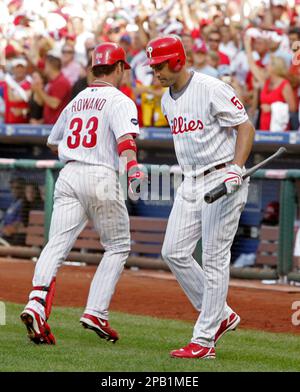 Philadelphia Phillies' Aaron Rowand, left, is congratulated by teammates  after scoring on a bases-loaded walk in the second inning of a baseball  game against the Atlanta Braves Tuesday, May 1, 2007, in