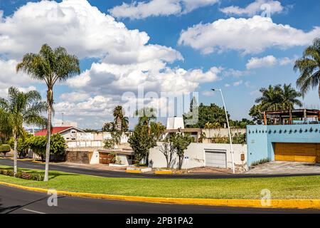 Zapopan, Jalisco Mexico. January 1, 2023. Cityscape with an empty vehicular avenue, median strip or central reservation, facades of residential houses Stock Photo