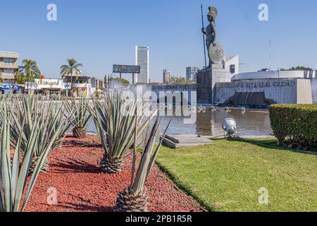 Guadalajara, Jalisco Mexico. January 8, 2023. Glorieta Minerva fountain with roman goddess against blue sky, agave and grass decorating, cityscape wit Stock Photo