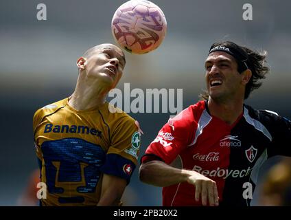 Dario Veron, left, of Pumas, fights to head the ball against Guillermo  Franco of Monterrey during the first game of the Mexican soccer championship  final at the University Stadium in Mexico City