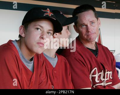 Houston Astros' Craig Biggio, right, gets emotional as he sits in the  dugout with his sons Connor, left, and Cavan and watches a tribute from his  family during the last baseball game of the season and his last as an Astro  against the Atlanta Braves Sun