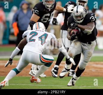 Miami Dolphins Renaldo Hill (24) applies pressure as Baltimore Ravens Mark  Clayton (89) is unable to catch a pass during the second half of their  Sunday, Jan. 4, 2009, NFL playoff football