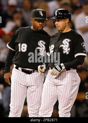 Chicago White Sox Scott Podsednik (22) high fives teammate Tadahito Iguchi  (15) before the start of