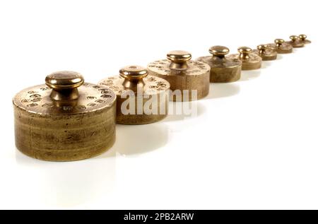 Old brass weights isolated on white background Stock Photo