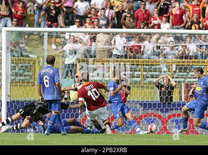 AS Roma's captain Francesco Totti, center with white jersey, sorrounded by  teammetes, holds the trophy with Italian President Giorgio Napolitano,  second from right, and Italian soccer league president Antonio Matarrese,  right, after