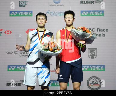 Muelheim, Germany. 12th Mar, 2023. Li Shifeng (R) of China and Ng Ka Long Angus of China's Hong Kong react during the medal ceremony after the men's singles final match at the Yonex German Open 2023 badminton tournament in Muelheim, Germany, March 12, 2023. Credit: Ren Pengfei/Xinhua/Alamy Live News Stock Photo