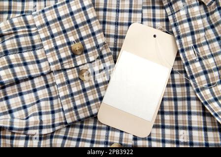 Men's shirt. Checkered shirt sleeve with buttons. Piece of clothing. Button. Tag on clothes Stock Photo