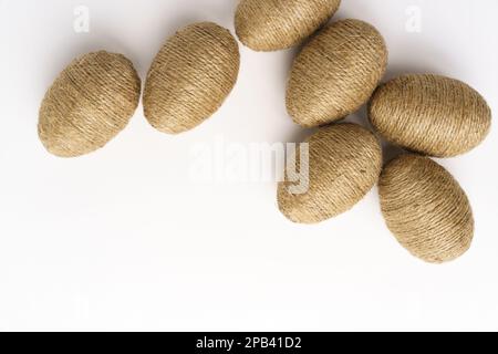 Hand wrapped easter eggs with jute twine, isolated white background. Studio Stock Photo
