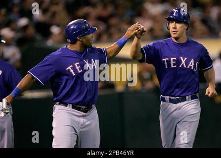 Texas Rangers' Gerald Laird, left, and teammate Jason Botts celebrate after  Botts hit a home run during a baseball game against the Minnesota Twins,  Sunday, April 27, 2008, in Arlington, Texas. (AP