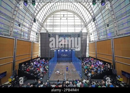 The crowd watch the action from the round one BO3 match between Victor Crouin (left, white top) and Sebastien Bonmalais during the Canary Wharf Squash Classic at the East Wintergarden, London. Picture date: Saturday March 12, 2023. Stock Photo
