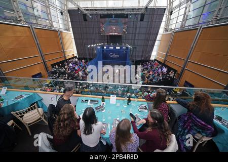 The crowd watch the action from the round one BO3 match between Victor Crouin (right, white top) and Sebastien Bonmalais during the Canary Wharf Squash Classic at the East Wintergarden, London. Picture date: Saturday March 12, 2023. Stock Photo