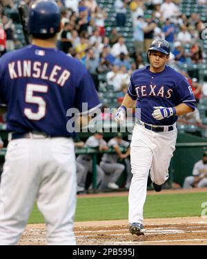 Texas Rangers' Ian Kinsler crosses the plate after hitting a home