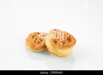 National Hungarian cuisine.Two buns with caraway seeds on a white mirror background. Stock Photo