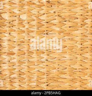 background of light yellow mat woven from reeds. Stock Photo