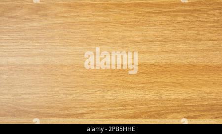 Background of a laminated panel imitating an old wooden board in dark yellow color. Stock Photo