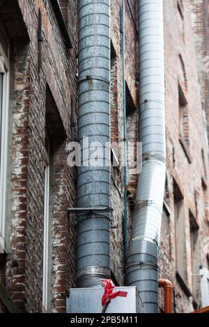 picture of ventilation pipes on the outside wall of an old brick building Stock Photo