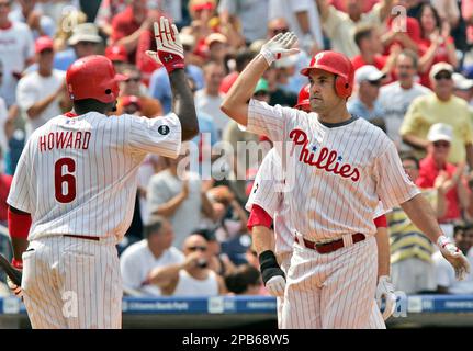 Former Philadelphia Phillies Pat Burrell (right, now of the Rays) and  Phillies' first baseman Ryan Howard (left) greet each other before the  start of a spring training game between the Tampa Bay