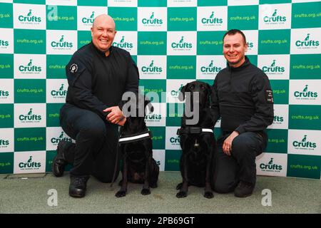 12th March 2023. Birmingham, UK. Ryan Gray with May & Kyle Murray with Delta from Northern Ireland Search & Rescue, who have just returned from working in Turkey following the earthquake attend the final day of Crufts 2023.    ©️Jon Freeman/Alamy Live News Stock Photo