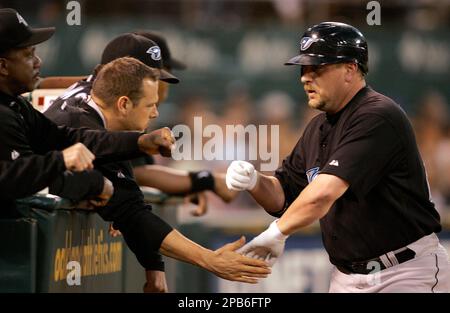 Toronto Blue Jays' Matt Stairs, right, is congratulated by teammates as he  returns to the dugout after hitting a solo home run off Oakland Athletics'  Chad Gaudin in the fourth inning of