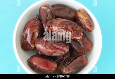 Close up picture of organic dates in a bowl, selective focus. Stock Photo