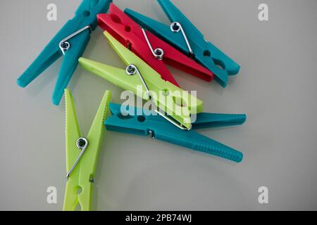 coloured plastic clothes pegs pins lying on a table in Lanzarote, Canary Islands, Spain Stock Photo