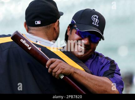 Vinny Castilla, left, special assistant to the general manager of the  Colorado Rockies, greets Chicago Cubs right fielder Carlos Gonzalez before  a baseball game Monday, June 10, 2019, in Denver. Gonzalez was