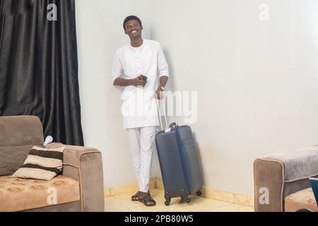 Full length body size side profile photo of man carrying his baggage holding passport and tickets Stock Photo