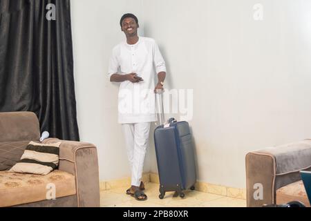 Full length body size side profile photo of man carrying his baggage holding passport and tickets Stock Photo
