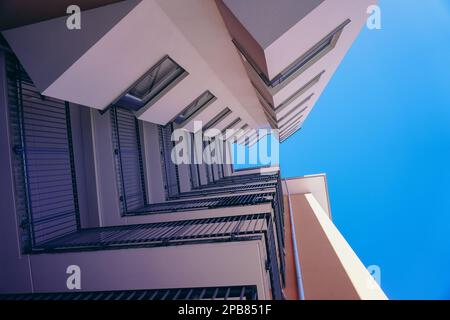 Directly below shot of buildings against clear sky Stock Photo
