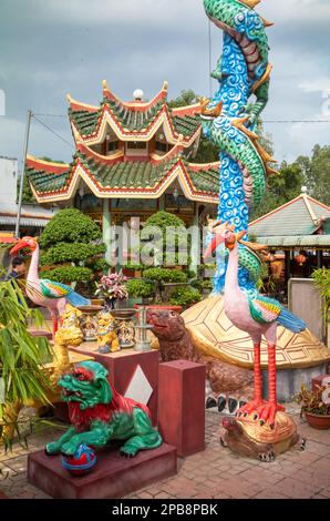 Colourful statues and trees at a Taoist temple in Tan Chau in the Mekong Delta, Vietnam. Stock Photo