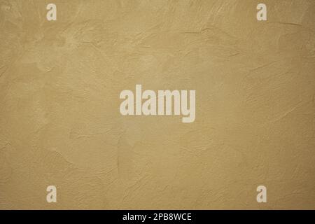 Abstract gold background with plaster texture on wall. Back focus blurred Stock Photo