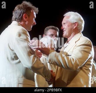 San Francisco 49ers QB Joe Montana kneeling with coach Bill Walsh