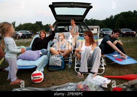 Family members from left, McKayla Adkins, 3, Joannie Presti, Samantha  Presti, 13, Matthew Presti, 17, Jill Calabrese, and Nathan Presti, 19,  enjoy food from their cooler they brought to the Mayfield Drive-In