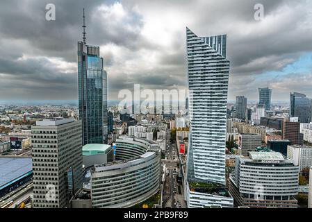 Warsaw. Złota 44 residential building and Złote Tarasy shopping center. This is a very exclusive commercial place in Warsaw.Photo in subdued colour. Stock Photo