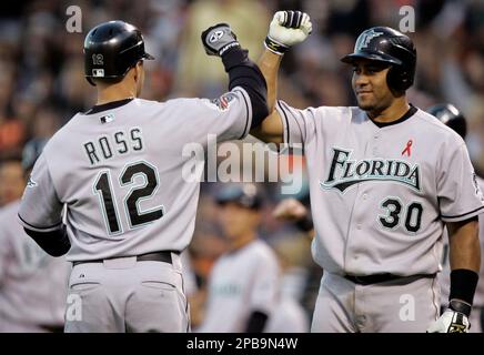 Florida Marlins' Miguel Olivo, right, celebrates with Aaron Boone