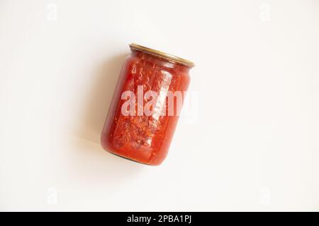 Canned glass jar of tomato juice isolated on white background Stock Photo