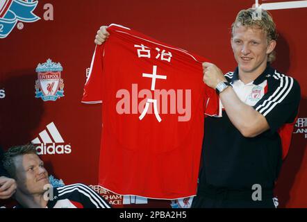 Liverpool s Dirk Kuyt raises a jersey with his name and number 18