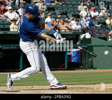 The Texas Rangers' Michael Young connects in the batting cage as teammate  Ian Kinsler looks on during spring training in Surprise, Arizona, Saturday  February 25, 2012. (Photo by Ron T. Ennis/Fort Worth