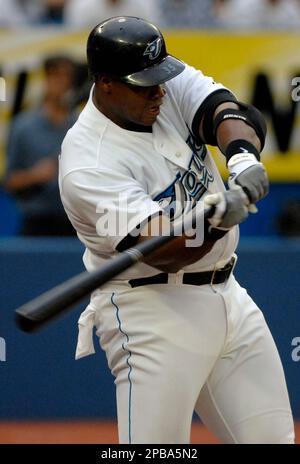 Toronto Blue Jays' Frank Thomas, left, reacts as he is held back by coach  Ernie Whitt after being tossed from the game by home plate umpire Bill  Miller, right, during fourth inning